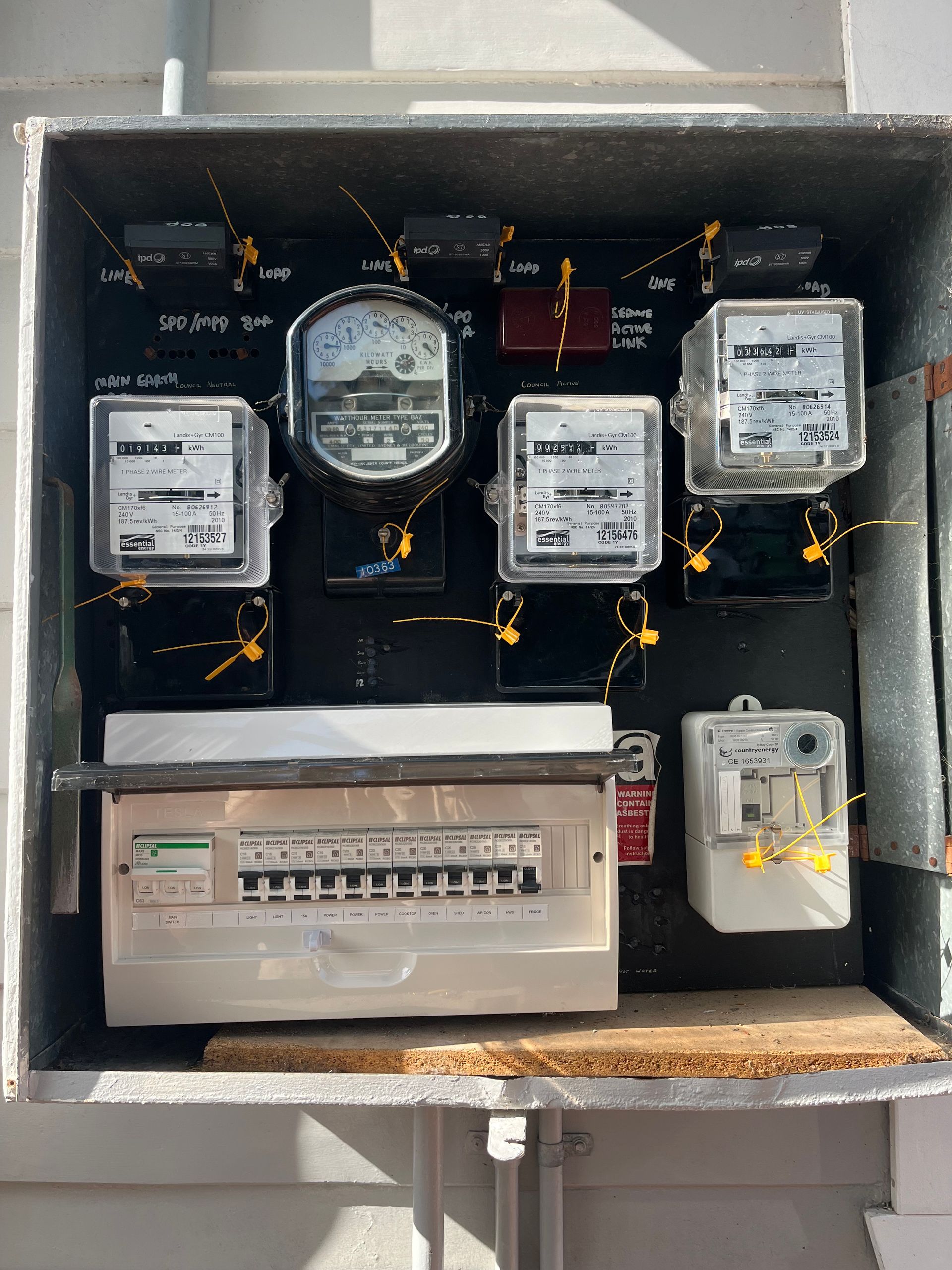 Electrical panel with multiple meters and circuit breakers inside a metal enclosure. — Neave Electrical in Forster, NSW