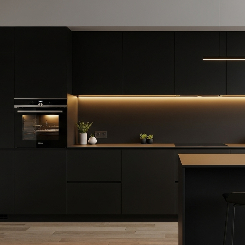 Modern black kitchen with built-in oven, island, and warm under-cabinet lighting. — Neave Electrical in Forster, NSW