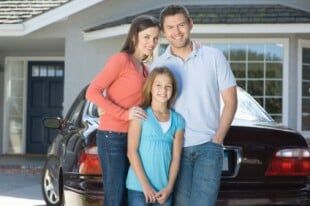 Family Standing in Front of Car in Driveway — Auto Insurance Agents in West Caldwell, NJ