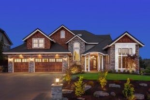 Home with Lights On During Sunset — Home Insurance Agents in West Caldwell, NJ