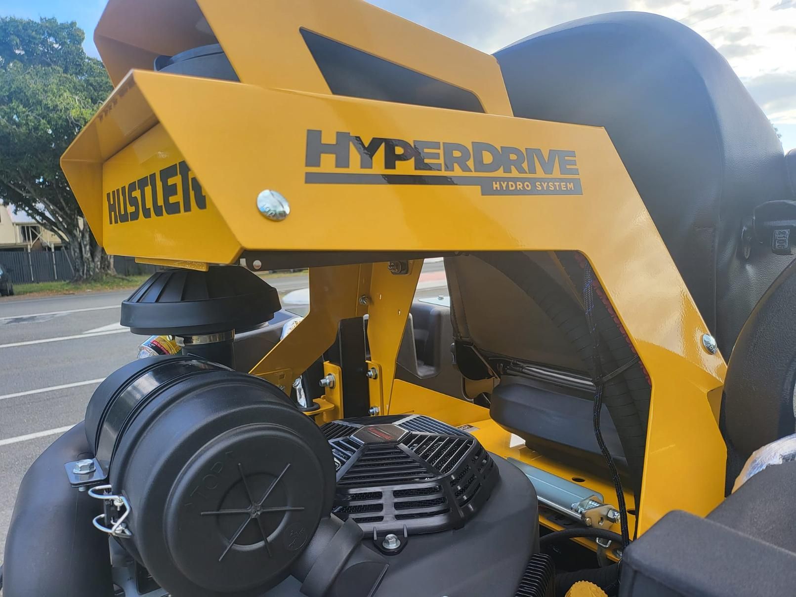 A Yellow Hyperdrive Lawn Mower Is Parked On The Side Of The Road — Cairns Mower City In Parramatta Park, QLD