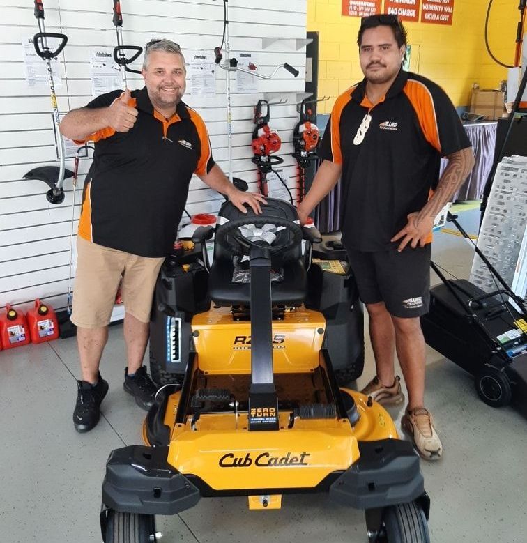 Two Men Standing Next To A Cub Cadet Lawn Mower — Cairns Mower City In Parramatta Park, QLD