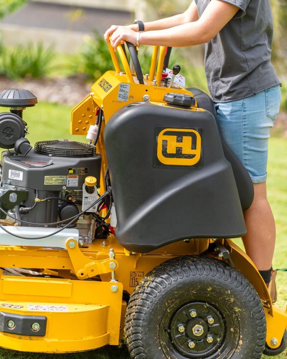 A Woman Is Sitting On A Yellow And Black Lawn Mower — Cairns Mower City In Parramatta Park, QLD