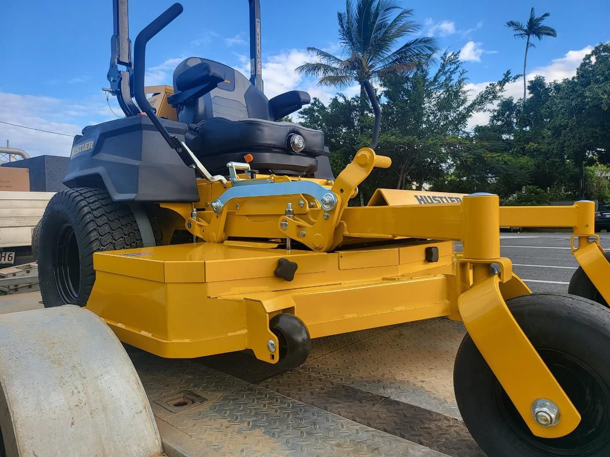 A Yellow Lawn Mower Is Parked On The Side Of The Road — Cairns Mower City In Parramatta Park, QLD