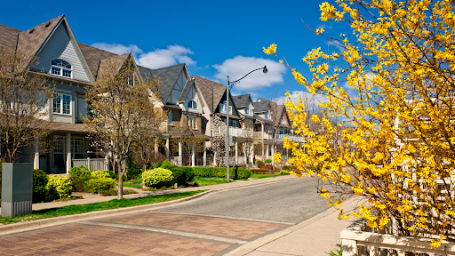 Homes for sale during springtime with blooming trees in the front yard.