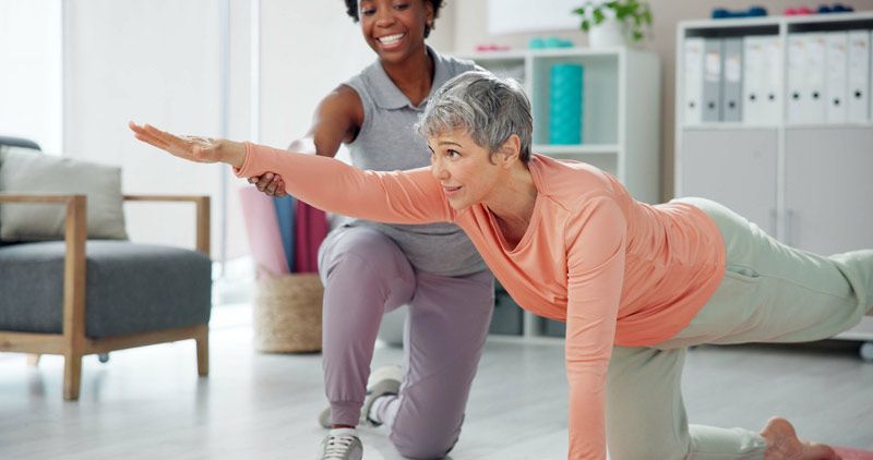 A trainer is helping a woman do Affordable Fitness How Home Training Saves You Money in NYC