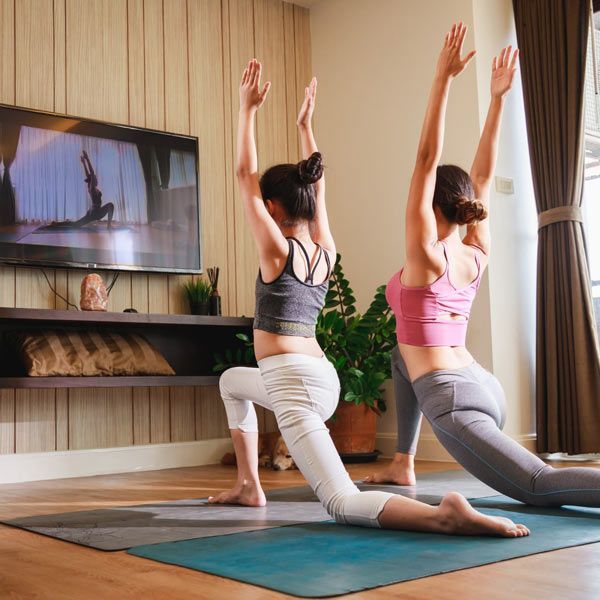 Two female HomeBodies Clients Taking a Virtual Yoga Personal Training Session