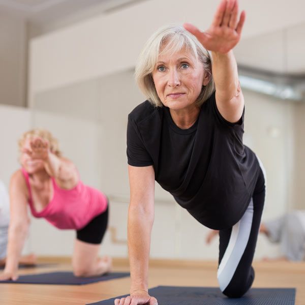 HomeBodies senior client taking a Hatha Yoga Personal Training Session at Home