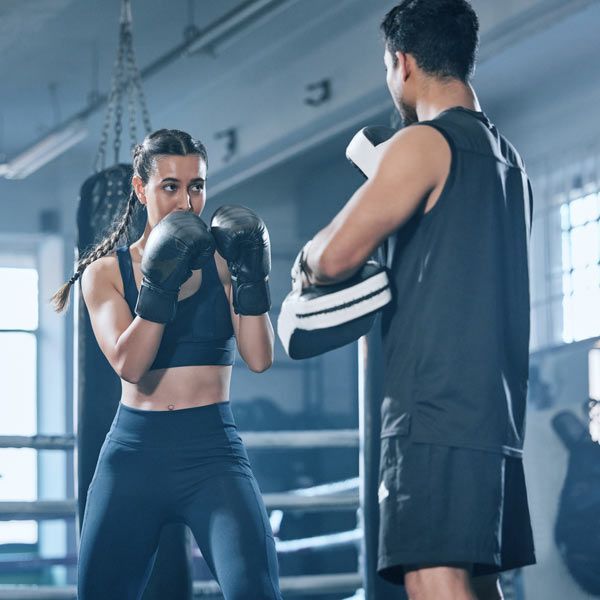 Woman Kickboxing Exercising with her NYC Home Fitness Trainer