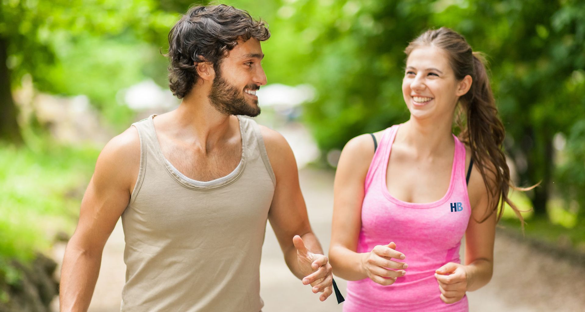 A man and a woman are walking down a path holding hands practicing Mindfulness and Movement