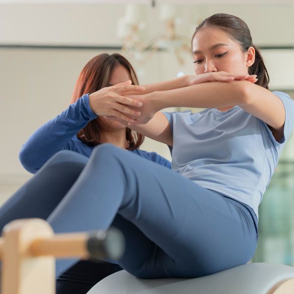 HomeTrainer Teaching a Client Pilates inn Manhattan NY