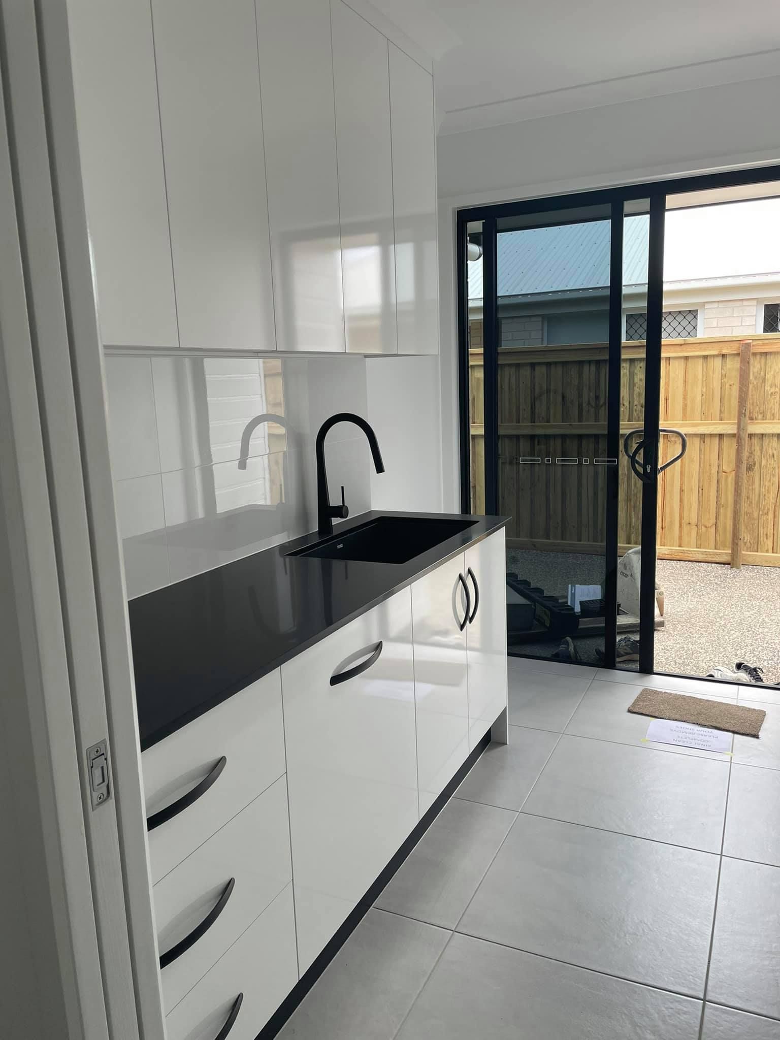 Black Kitchen Sink with White Cabinets — Painters in Bundaberg, QLD