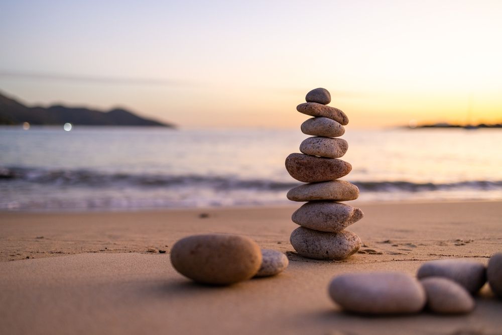 A pile of rocks stacked on top of each other on a beach.
