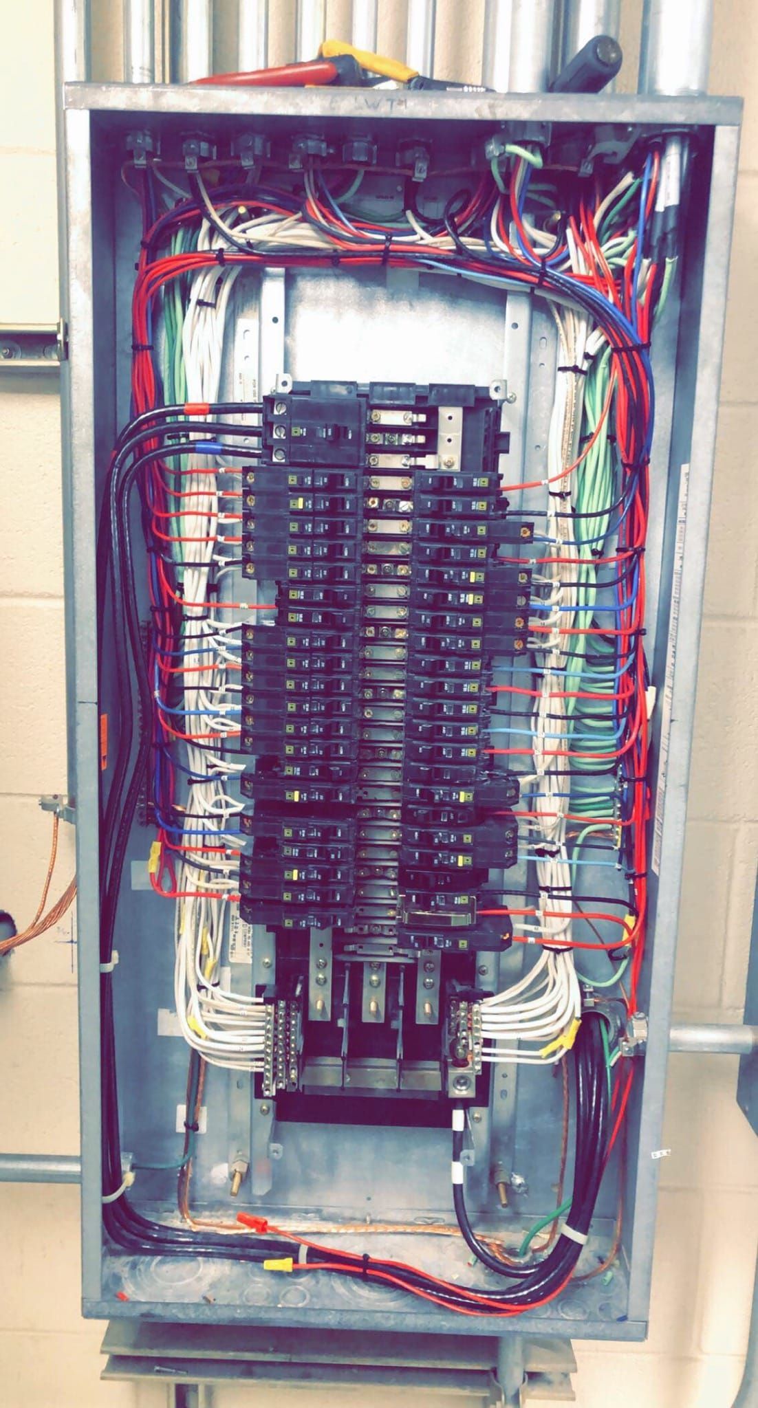 A very large electrical box with a lot of wires coming out of it.
