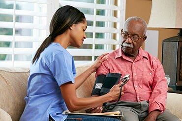 Nursing Home — Nurse Measuring Blood Pressure in Central City, NE