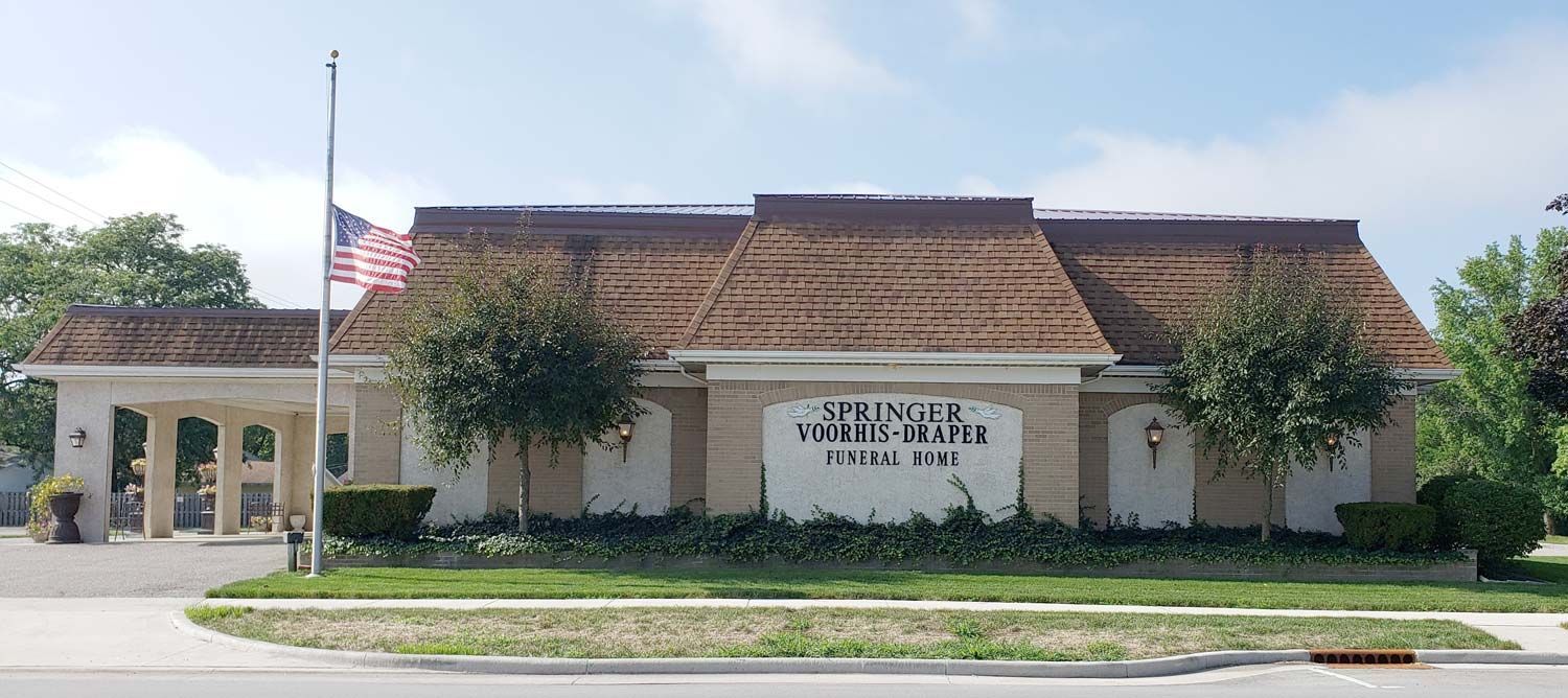 Springer-Voorhis-Draper Funeral Home exterior with flag pole