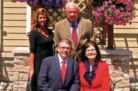 Springer-Voorhis-Draper Funeral Home history with four people on the side of their location with