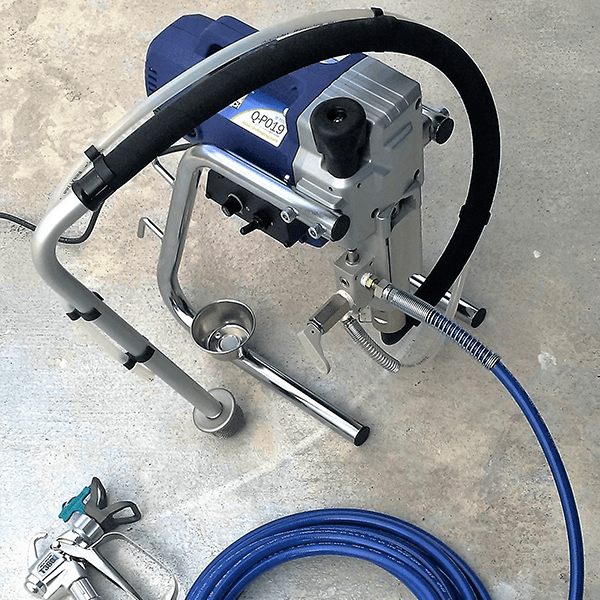 A paint sprayer with a blue hose attached to it