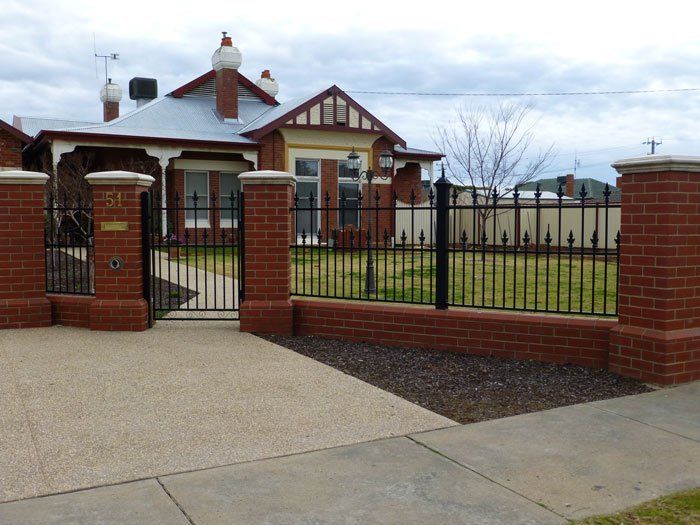 brick house with iron fence