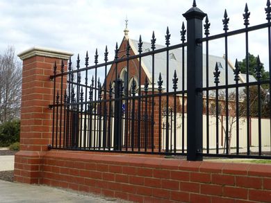 building with brick and iron fence