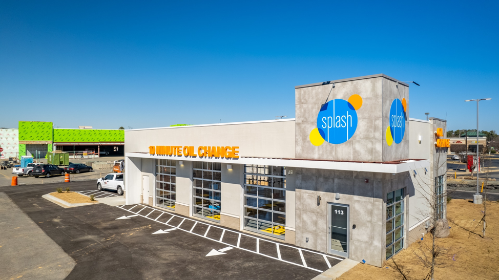 An aerial view of a splash car wash in a parking lot