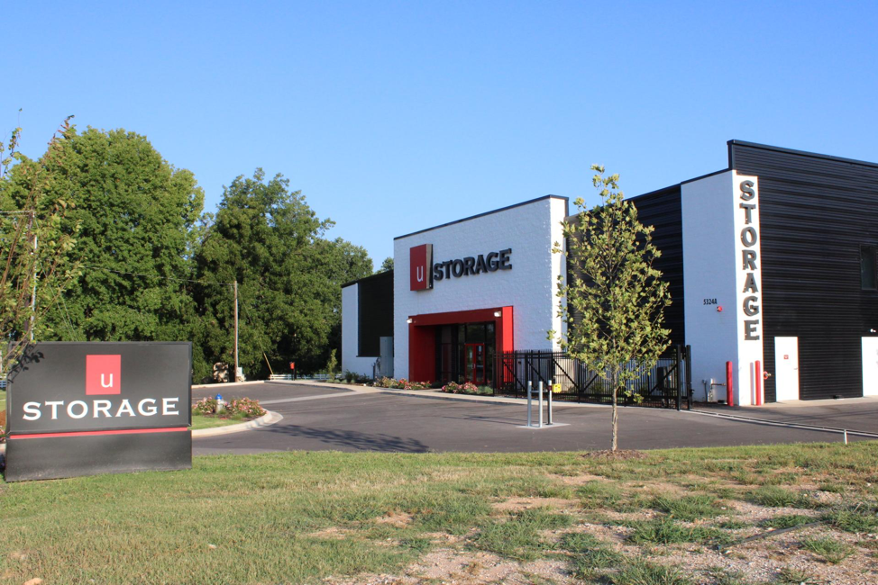 A storage building with a sign in front of it
