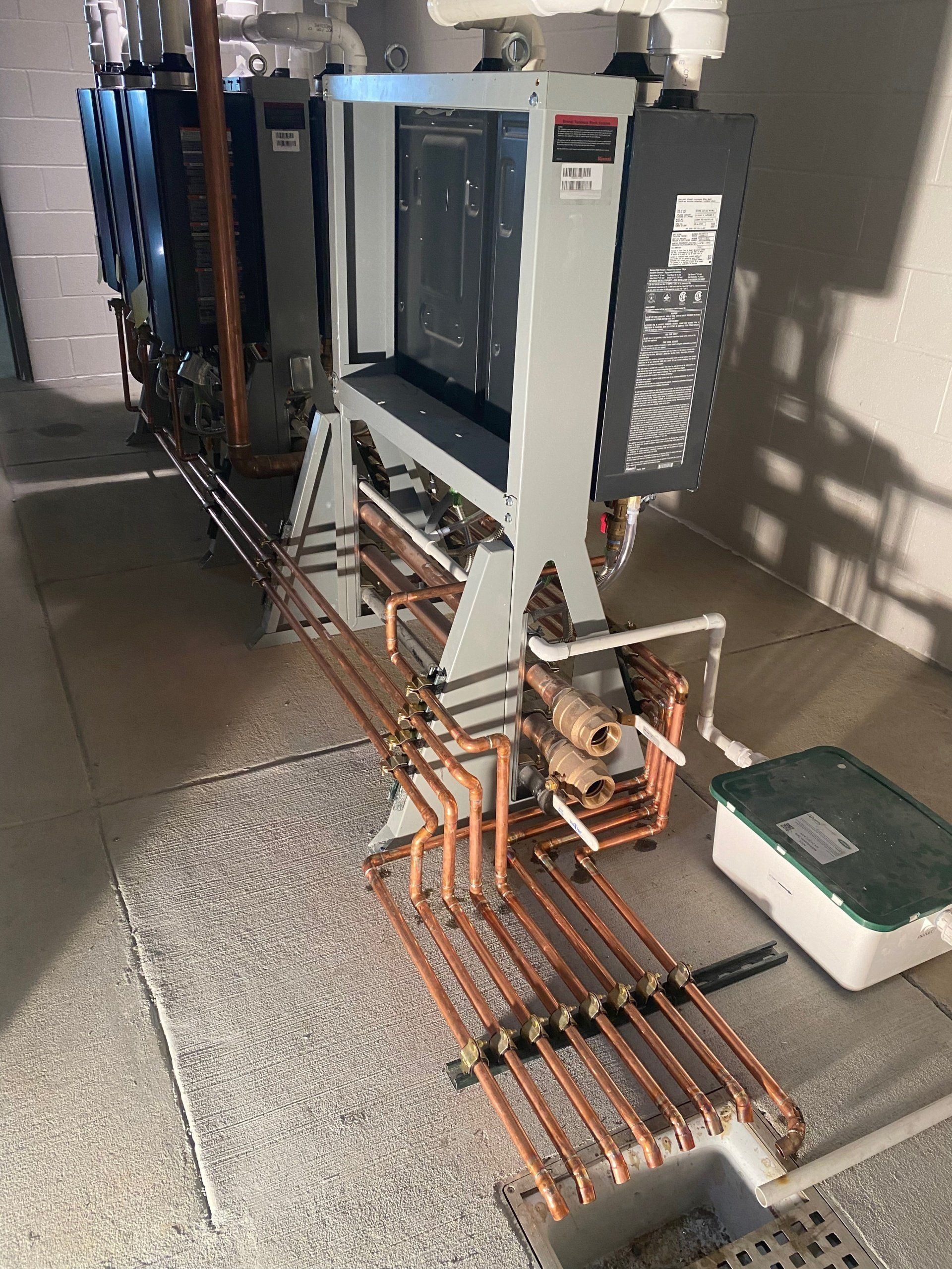 A machine with copper pipes coming out of it is sitting in a room.