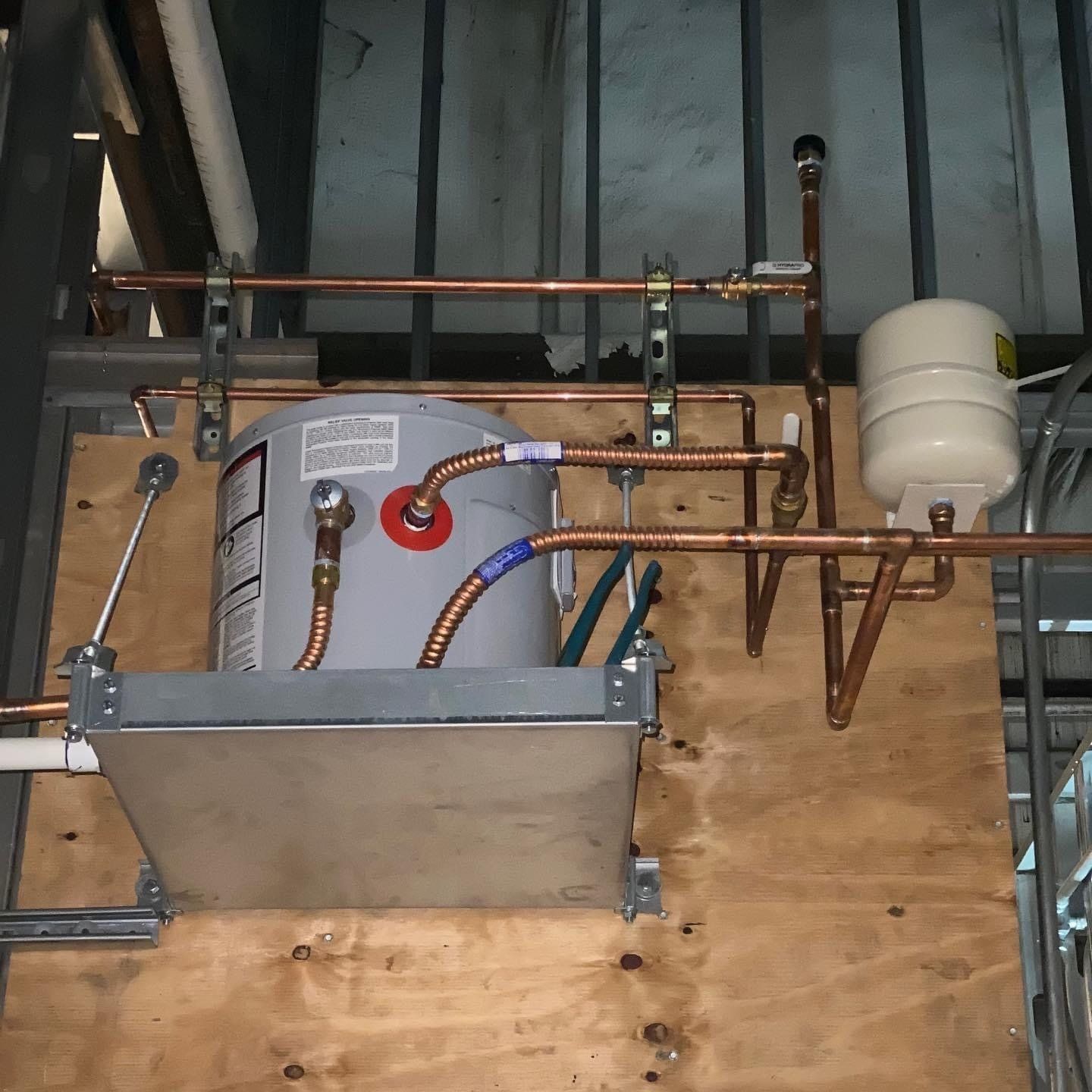 A water heater with copper pipes attached to it