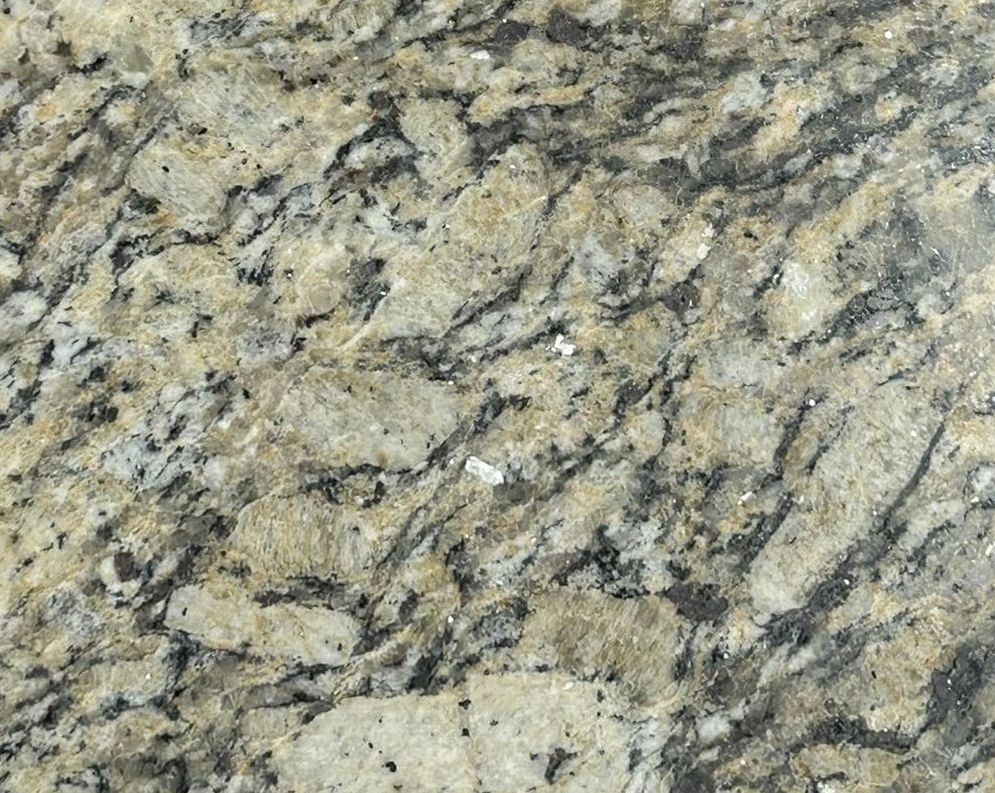 A piece of granite is sitting on a concrete surface.