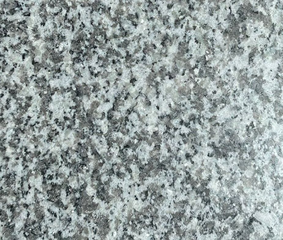 Two pieces of granite are sitting on a concrete surface.