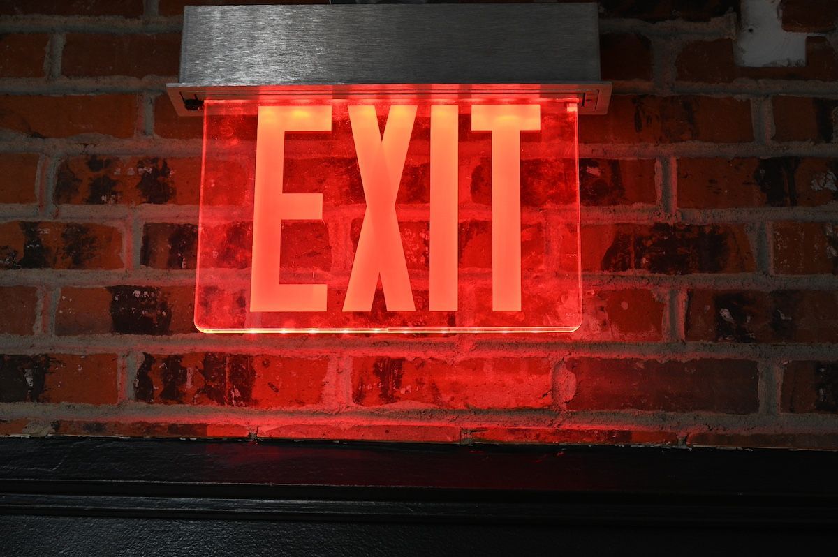 A Red Emergency Exit Sign. Korsmeyer Fire Protection Installs Emergency Lighting in Mid-Missouri.