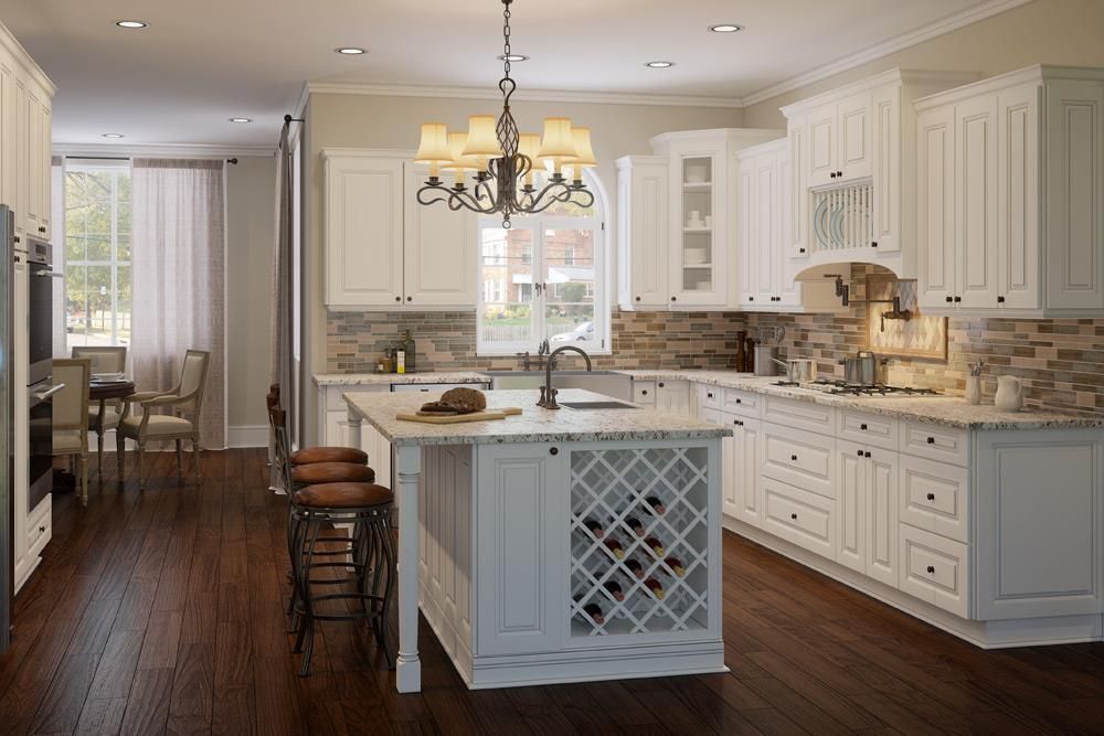 White kitchen with island, wine rack, stone backsplash, and dark wood floors.