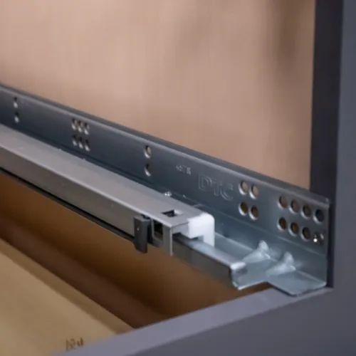 Drawer slide hardware mounted inside a gray cabinet. Metal slides and a white plastic piece are visible.