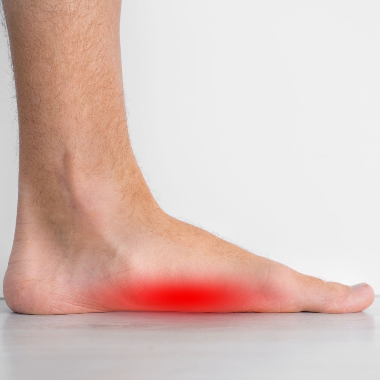 A close up of a person 's foot with a red spot on it.