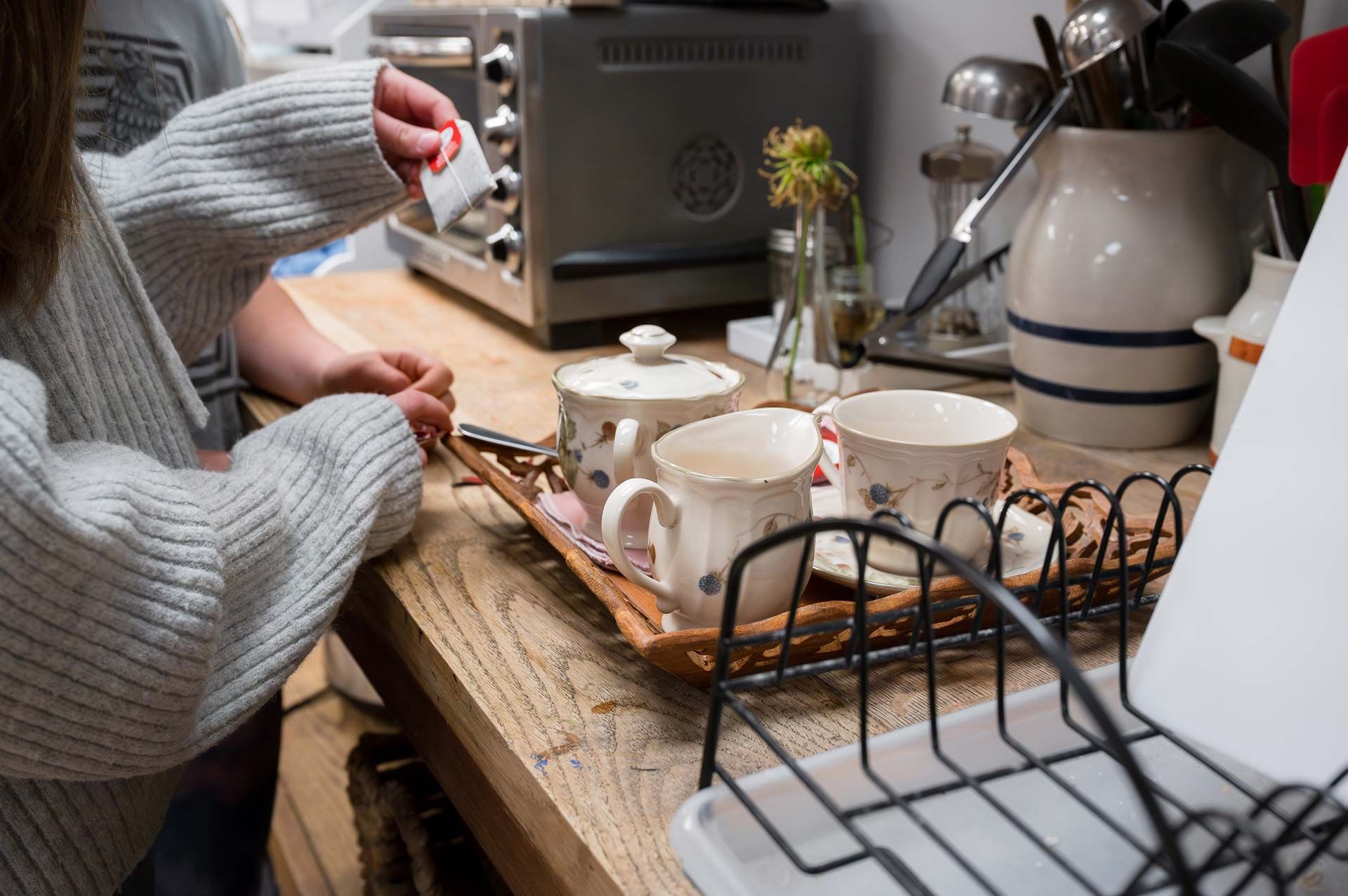 Montessori guide and child preparing tea in cozy kitchen