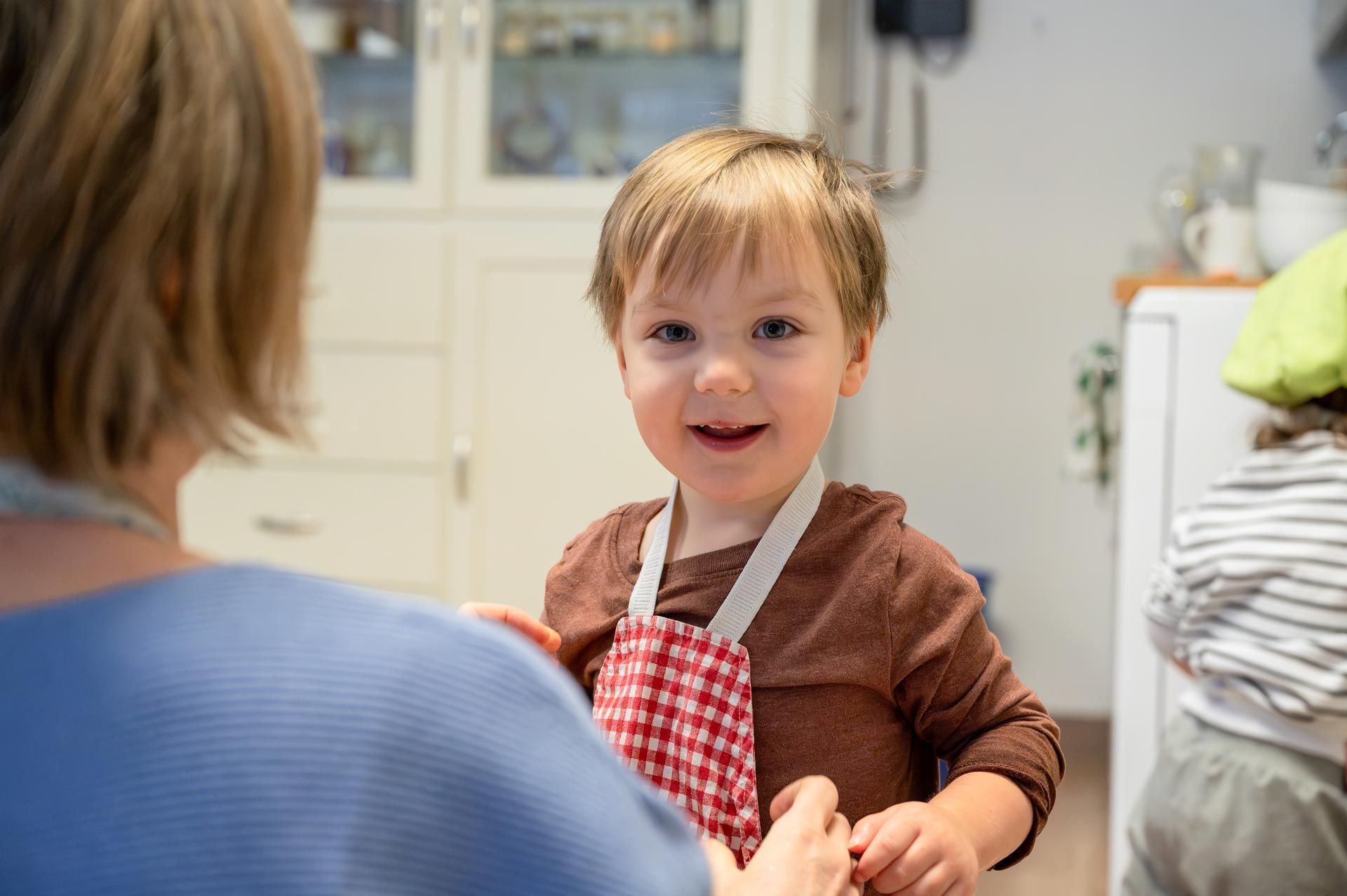 montessori child in a kitchen activity with guide