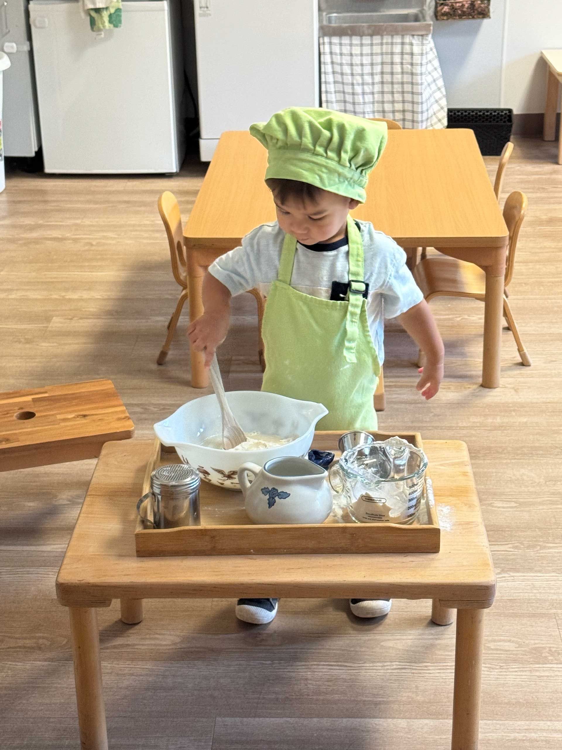 montessori child engaged in creative work at table