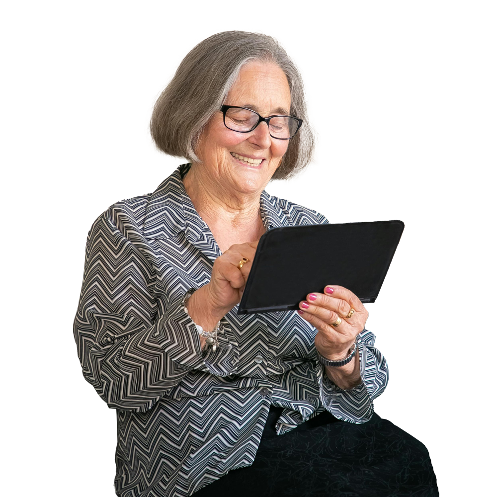 An elderly woman is sitting down using a tablet computer.