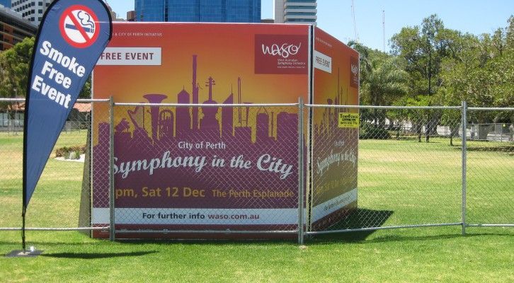 A fenced in area with a sign that says symphony in the city