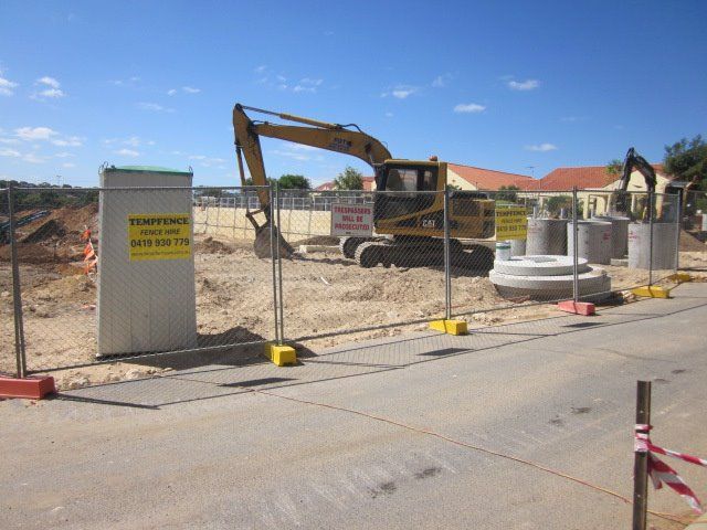 A construction site with a yellow sign that says ' demolition ' on it
