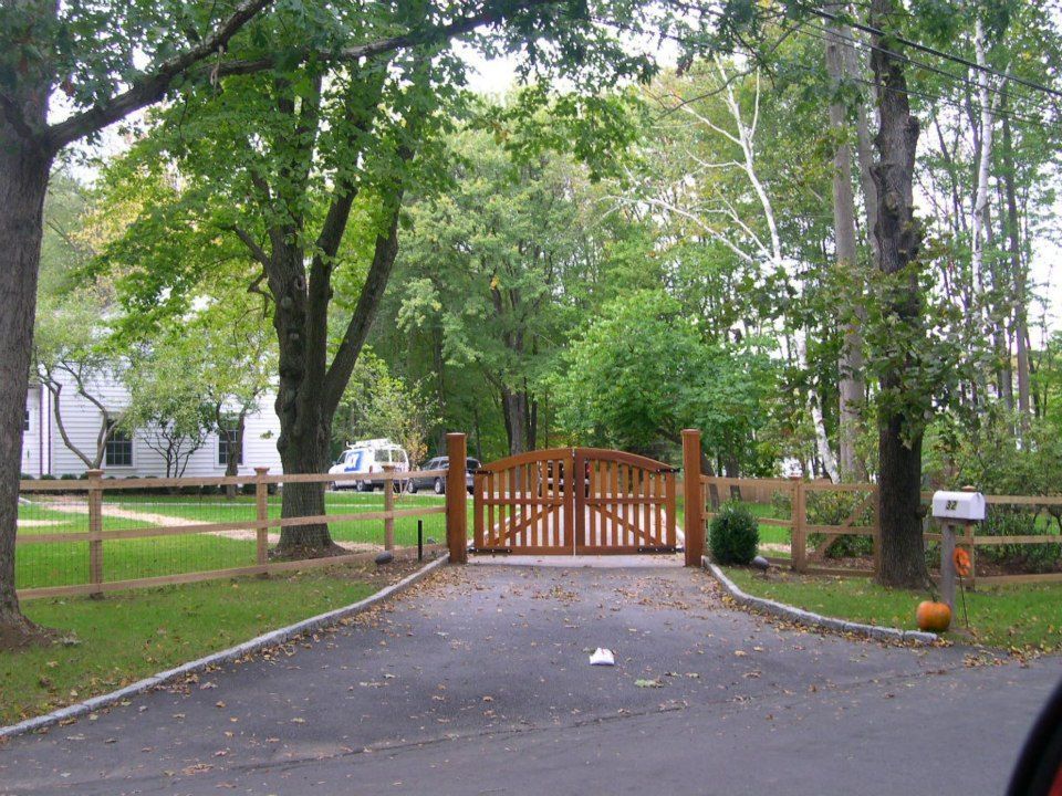 Stone steps with a black metal railing lead down to a basement door set into a stone building foundation.