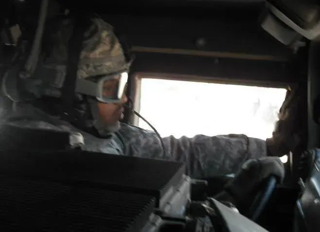 A man wearing a helmet and goggles is driving a vehicle