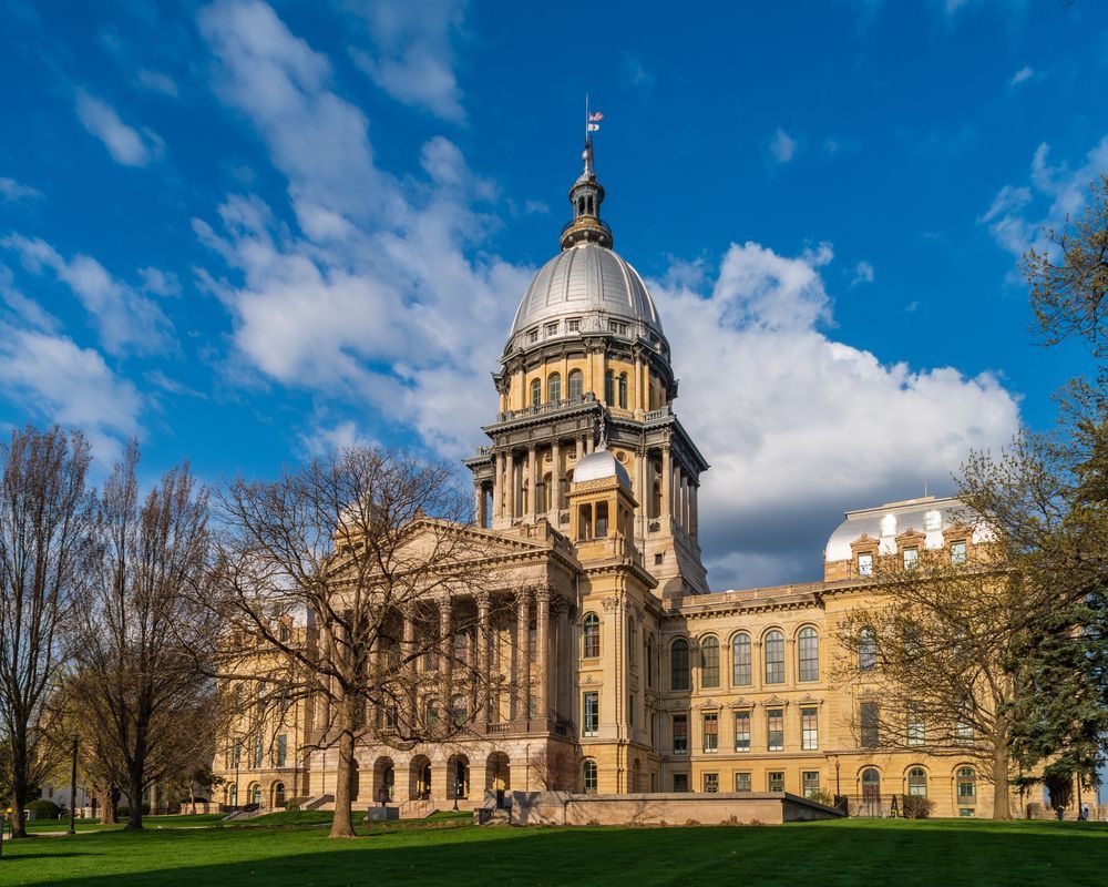Illinois State Capitol building with dome under a blue sky.