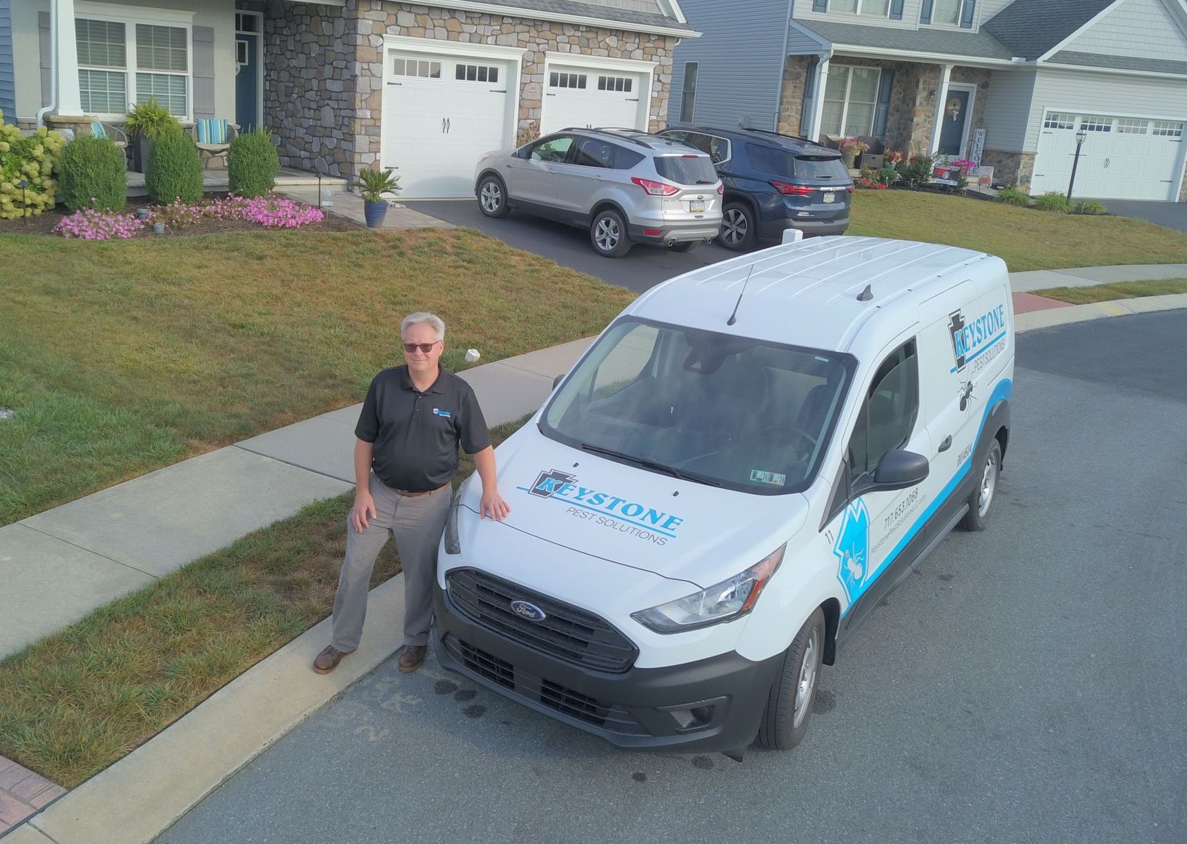 Rob of keystone pest solutions LLC standing outside of their service van near Lancaster PA