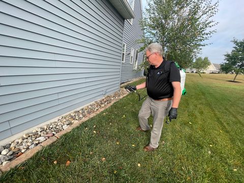 Rob of keystone pest solutions LLC spraying a home with insect treatment near Lancaster PA