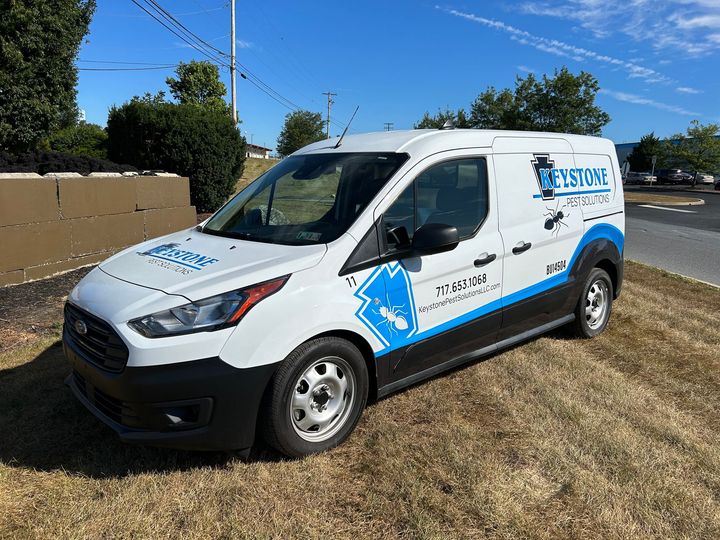 a white keystone pest solutions LLC van is parked on the side of the road in Mount Joy PA
