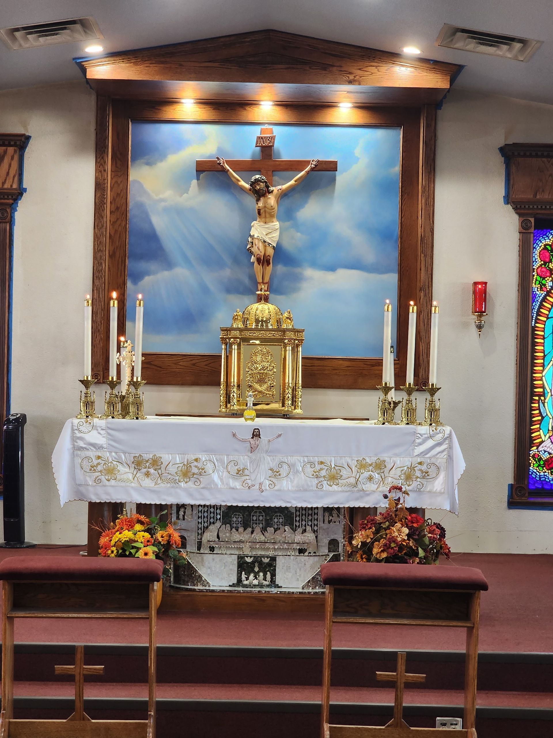 Kitchen under construction with white cabinets, island, and new hardwood floor.