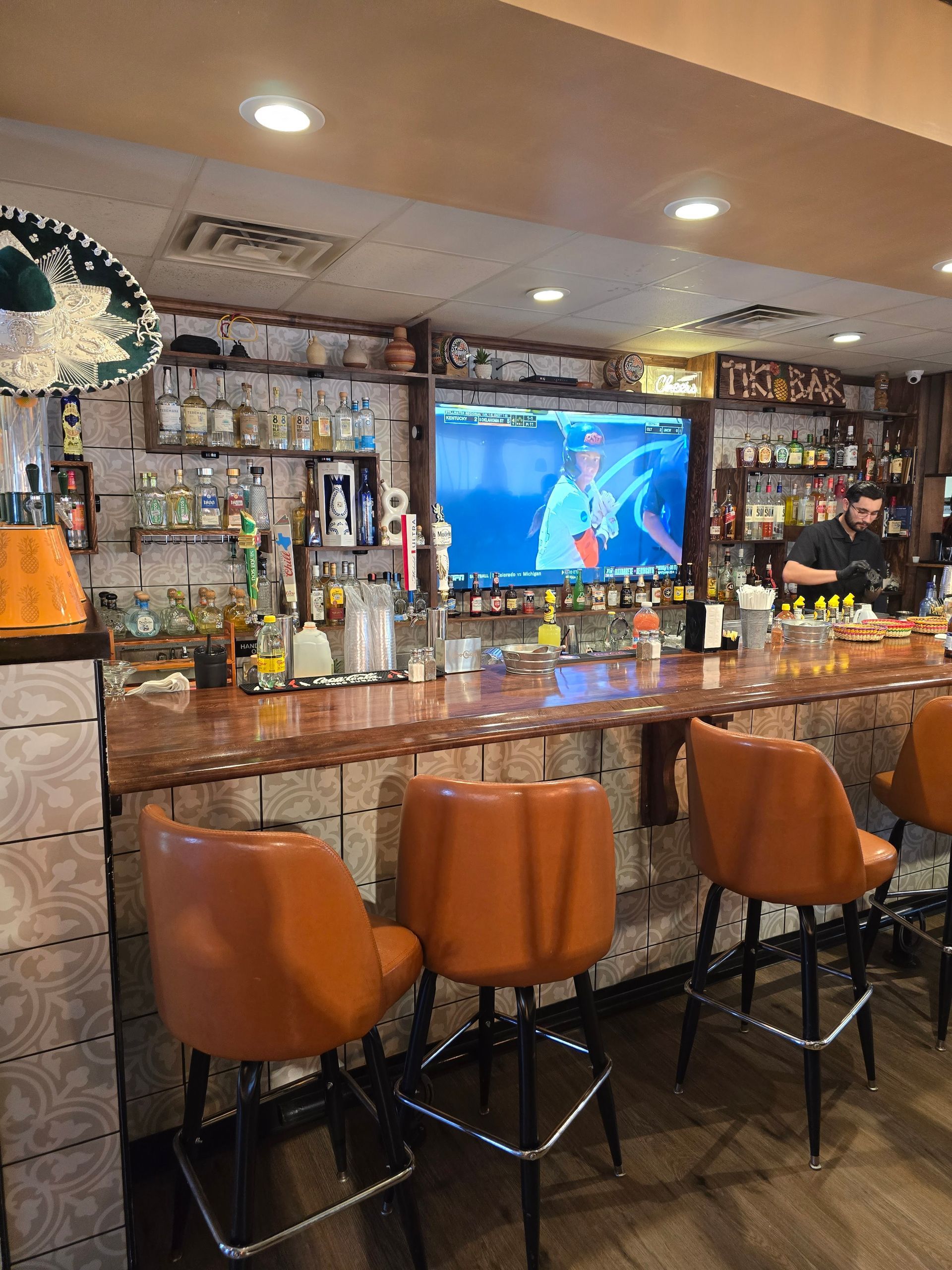 Dark wood drawers with gold handles in a room.