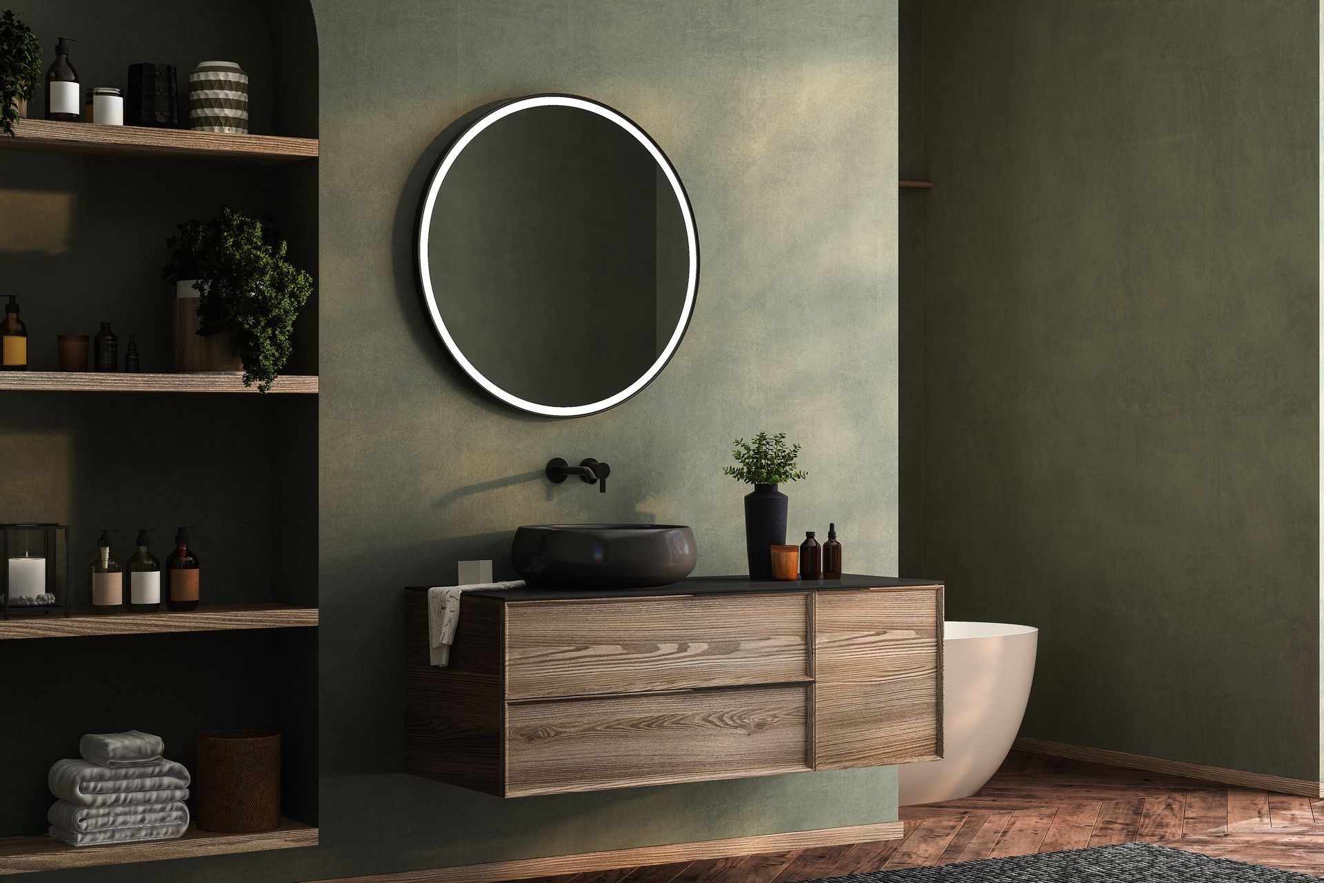 Bathroom with floating wood vanity, round backlit mirror, and open shelving on olive green wall.