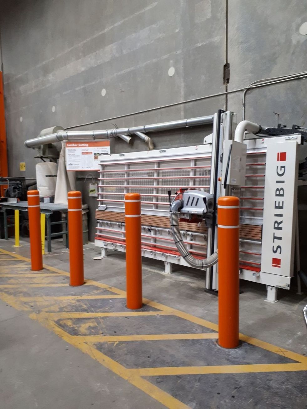 A warehouse with orange bollards installed